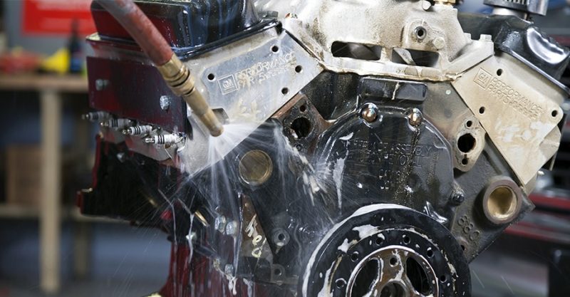 Washing an engine. Vesco offers parts washing services in Michigan.